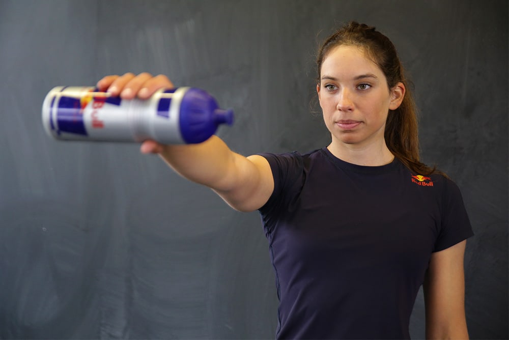 Woman doing an exercise with a workout bottle