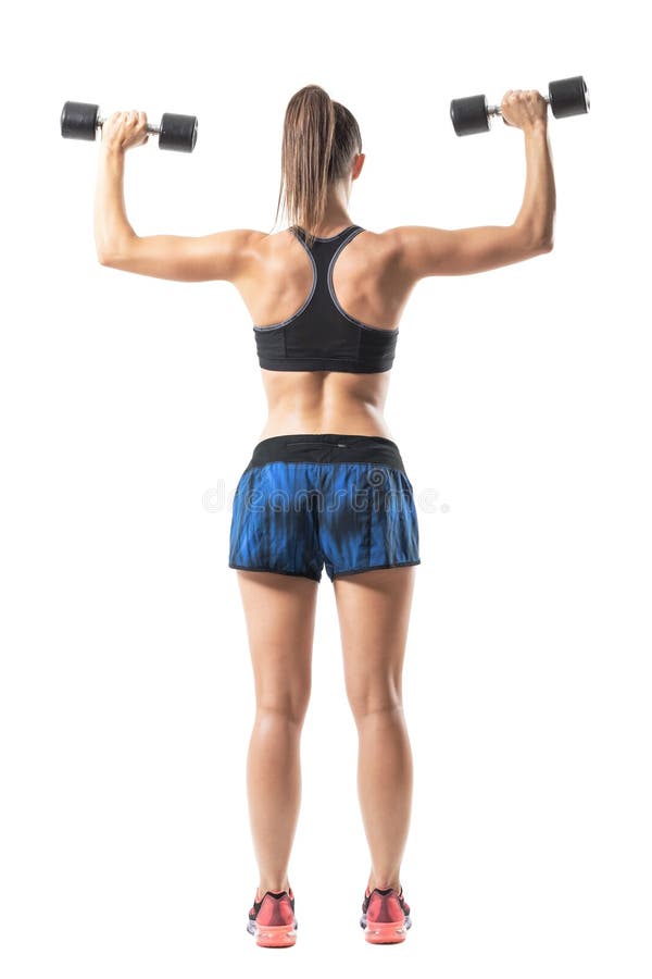 Back view of gym woman doing shoulders and back exercise with weights. Lower arm position. Full body length portrait isolated on white background stock photography