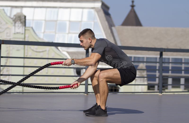 Built young sportsman. Practice exercises for hands and shoulders. Healthy life.Good condition royalty free stock images