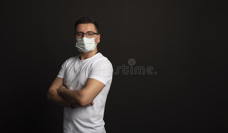 Coronavirus, Bio Protection Concept. Close up profile portrait of handsome bald man wearing medical mask, black turtleneck and stock photography