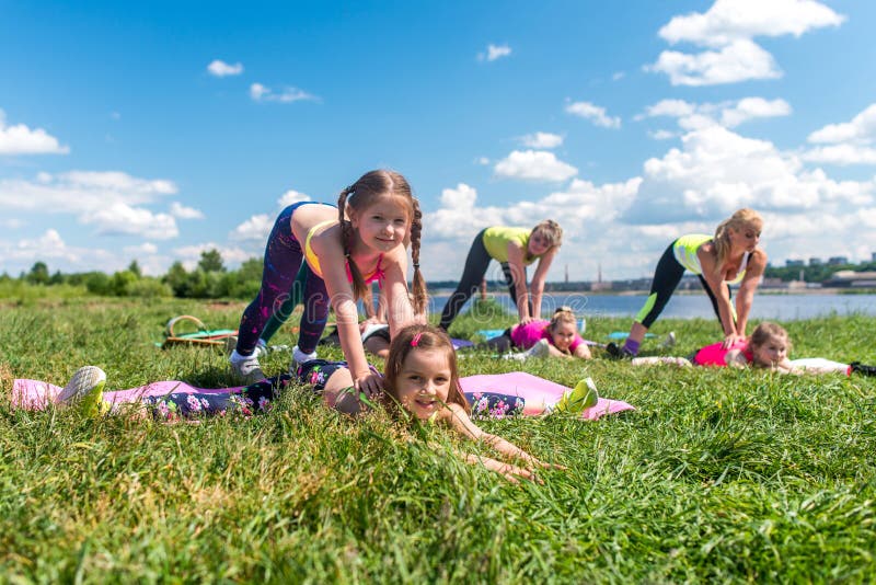 Group of girls doing stretching exercising training outdoors. stock images