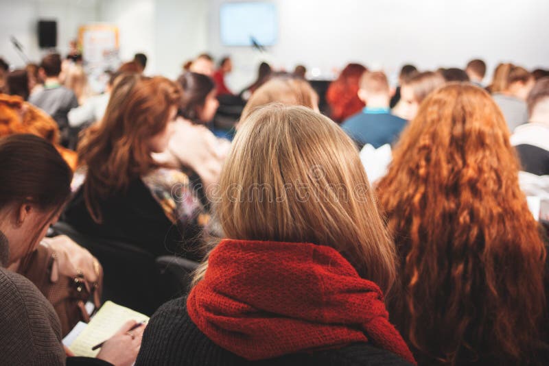 Group of young women schoolgirls girls students and people listening on the conference training education in the hall classroom stock image