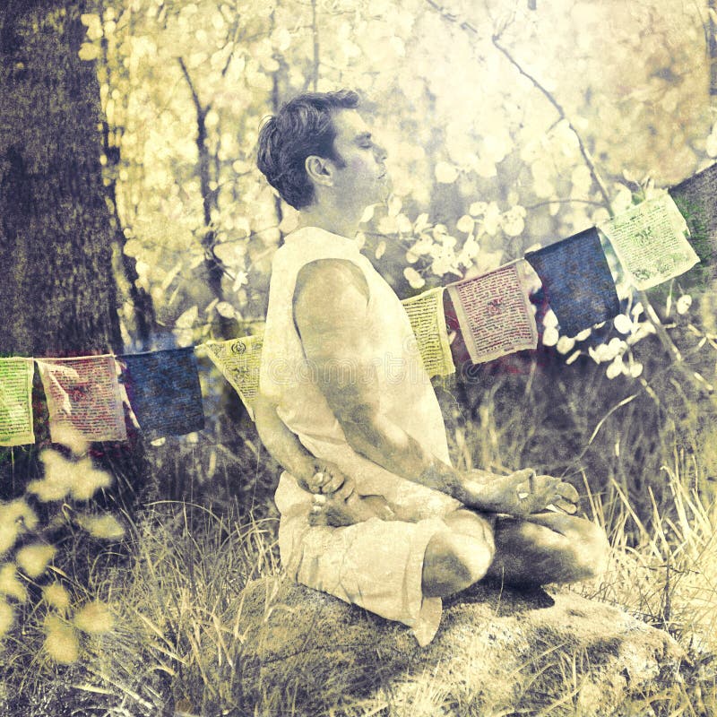 Spiritual Forest Yoga Meditation Man. Man practicing yoga twist in the forest in front of a string of Tibetan Prayer Flags. Color processed photo royalty free stock photos