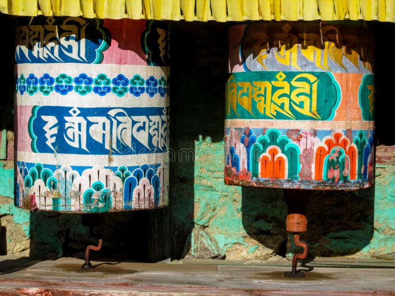Prayer wheel in Nepali near the Buddhist temple. Round rotating prayer wheel Nepali drum in the Buddhist temple in the Himalayas, Nepal. A colorful Nepali drum royalty free stock photos