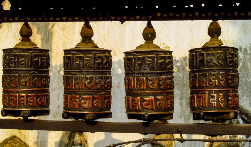 Prayer wheel in Nepali near the Buddhist temple. Round rotating prayer wheel Nepali drum in the Buddhist temple in the Himalayas, Nepal. A colorful Nepali drum stock images