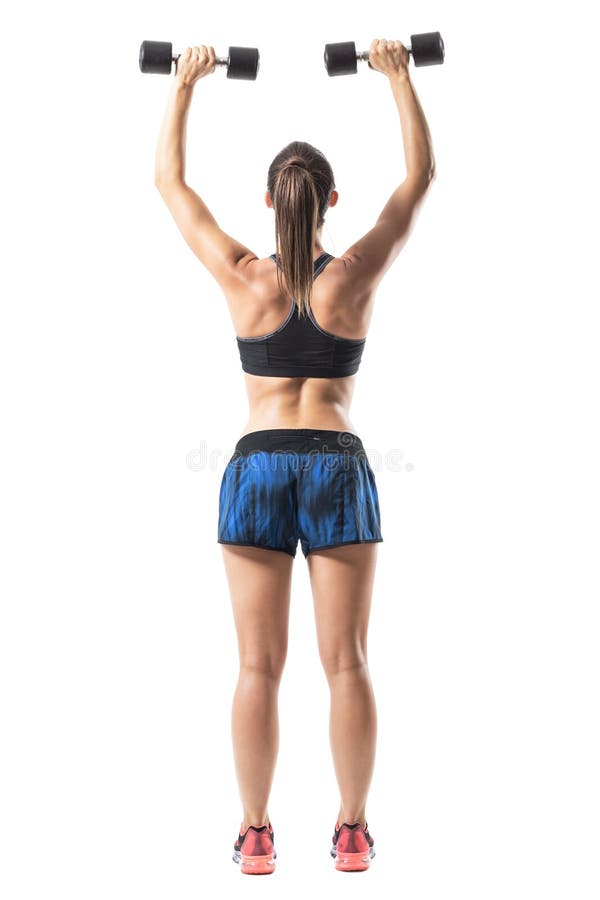 Rear view of fitness woman weightlifting doing shoulders back exercise with extended arms. Full body length portrait isolated on white background royalty free stock photo