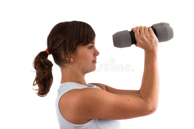 Shoulder exercises. Pretty brunette doing some shoulder exercises with dumbbels stock images