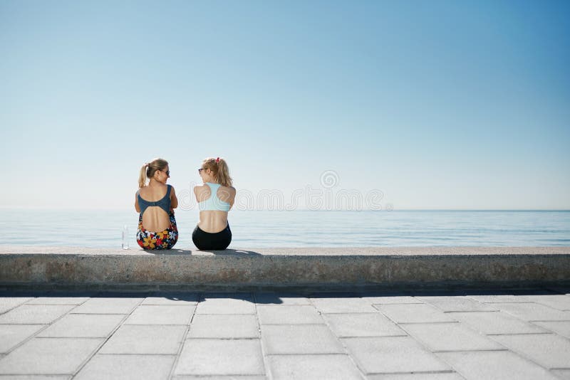 Sport fitness girls relaxing after training outdoor. stock photos