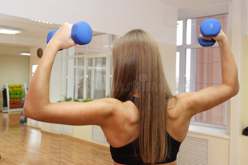 Sport girl with strong back. Beautiful Girl in Fitness Gym Photoshoot. More images of this models you can find in my portfolio stock photos