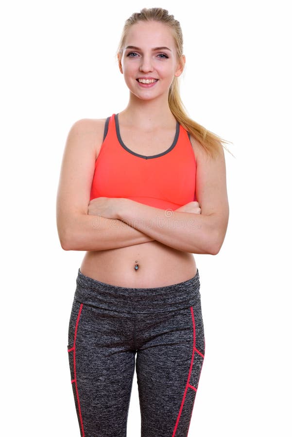 Studio shot of young happy teenage girl smiling with arms crosse. D ready for gym royalty free stock image
