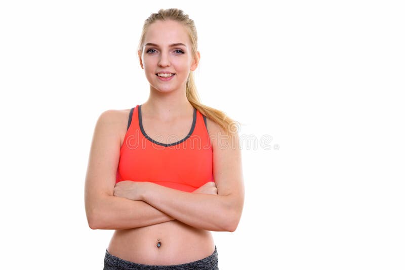 Studio shot of young happy teenage girl smiling with arms crosse. D ready for gym royalty free stock photography