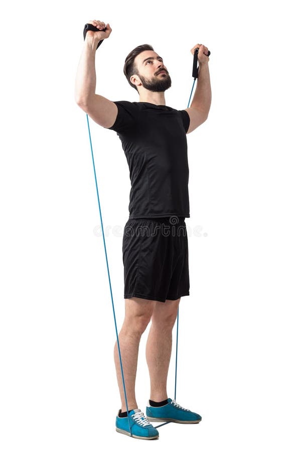 Young bearded athlete doing shoulders exercise with resistance elastic bands. Full body length isolated over white studio background royalty free stock image