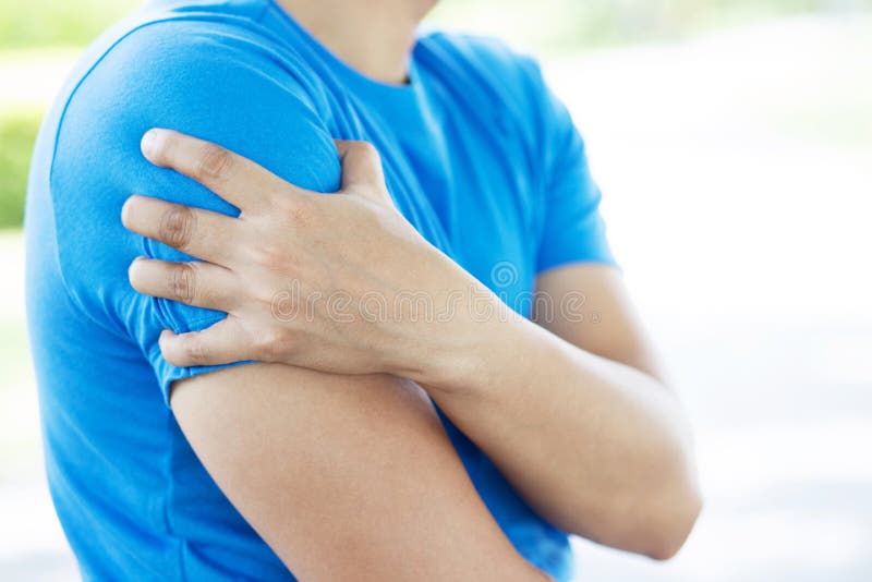 Young man touching painful twisted or broken shoulder. Athlete training accident. Sport Exercise is not warm, causing injury. and. Pain with arm bones. Health stock images