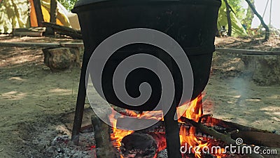 Close up view of balck pot on fire. Lunch for tourists after hiking. Close up view of balck pot on fire stock footage