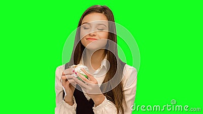 Girl eating hamburger Hiding that it could not be seen Have fun very strong And the shows Like. Girl eating hamburger Green screen keying in a single click stock video footage