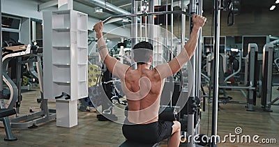 Hard working guy at gym doing exercises on his triceps muscles concentrated with a perfect muscle body working on gym. 4k stock footage