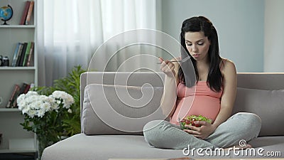 Pregnant girl observing correct diet, eating healthy vegetable salad, vitamins. Stock footage stock video