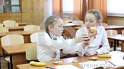 School lunch for children on the break between classes. Schoolgirl girls dine at school with apples, fruit and sandwiches with cheese and sausage stock footage