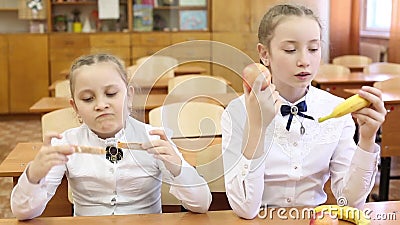 School lunch for children on the break between classes. Schoolgirl girls dine at school with apples fruit and sandwiches with cheese and sausage stock video footage