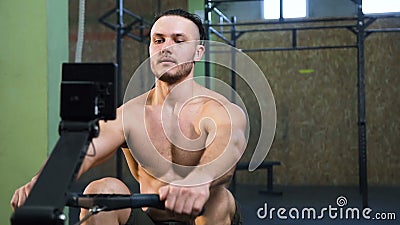 Strong young man training back on the sport simulator in the gym. Strong young man with naked torso training back on the sport simulator during crossfit stock video footage