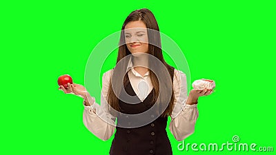 Woman choosing to eat burger instead of apple. Green screen keying in a single click, correct skin stock video footage