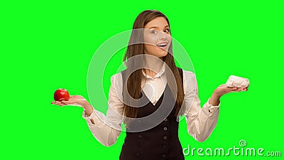 Woman choosing to eat burger instead of apple Selects hamburger. Woman choosing to eat burger instead of apple Green screen keying in a single click, correct stock video