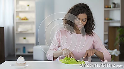 Young beautiful woman choosing salad over cake and eating, healthy food. Stock footage stock video