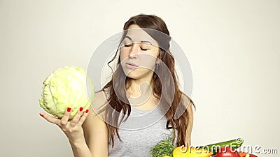 Young woman holding a basket, gets out of the basket head of cabbage and assesses its.  stock video footage