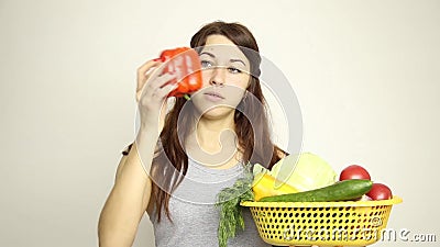 Young woman holding a basket, gets out of the basket of red pepper and assesses its.  stock video