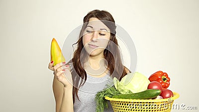 Young woman holding a basket, gets out of the basket of yellow pepper and assesses its.  stock video footage