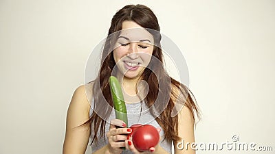 Young woman holding two tomatoes and expresses different emotions. healthy food - strong teeth concept.  stock video