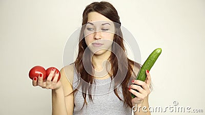 Young woman holding two tomatoes and expresses different emotions. healthy food - strong teeth concept.  stock video footage