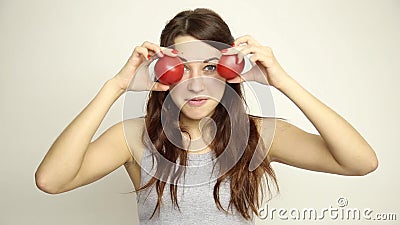 Young woman holding two tomatoes and expresses different emotions. healthy food - strong teeth concept.  stock video