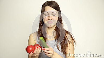 Young woman holding two tomatoes and expresses different emotions. healthy food - strong teeth concept.  stock video